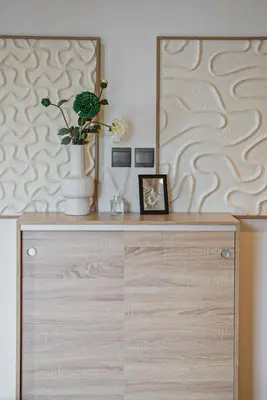 a dresser with a mirror and a vase with flowers on it at Brand new 2BR in Downtown 5 min walk to Burj Khalifa in Dubai