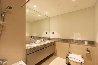 a bathroom with a sink and a toilet and a mirror at Brand new 2BR in Downtown 5 min walk to Burj Khalifa in Dubai