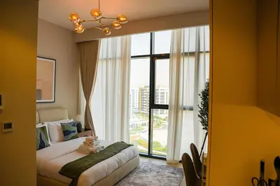 a bedroom with a bed with a teddy bear on it at New Studio in Meydan With Pool & Gym in Dubai