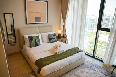 a bedroom with a bed with a teddy bear on it at New Studio in Meydan With Pool & Gym in Dubai