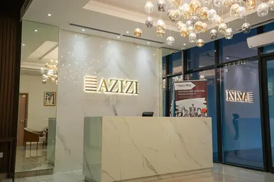 a lobby with a wall with aania sign on it at New Studio in Meydan With Pool & Gym in Dubai