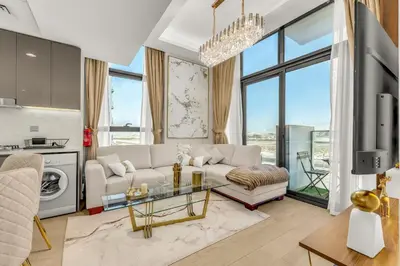 a living room with a couch and a table at Stylish 1BR with Pool Gym and Parking in Riviera 12 in Dubai