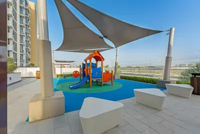 a playground with a slide in a building at Stylish 1BR with Pool Gym and Parking in Riviera 12 in Dubai