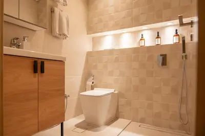 a bathroom with a toilet and a shower at Homely Creek Harbour Apartment - Direct Park Access in Dubai
