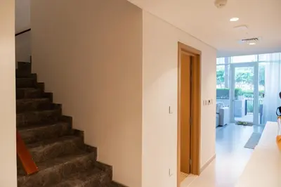a staircase in a home with a stair case at Homely Creek Harbour Apartment - Direct Park Access in Dubai