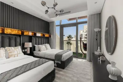 a hotel room with two beds and a large window at Gogoto4 - 2BR High Floor Burj View Infinity Pool PS5 NYE Fireworks View in Dubai
