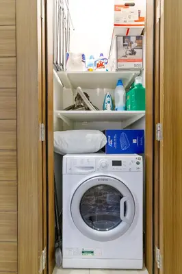 a washer and dryer in a small room at Modern House with Huge Private Garden in JVC in Dubai
