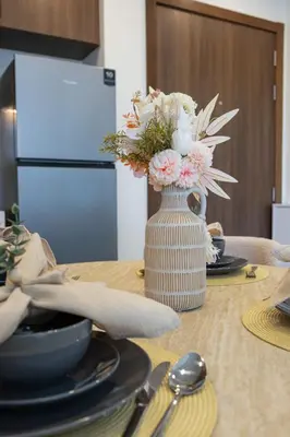a vase filled with flowers sitting on a table at Luxury 1BR Apartment Dubai in Dubai