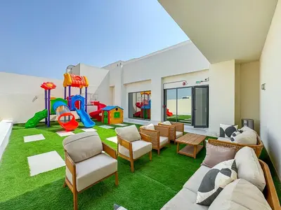 a living room with a play room with a playground at Chic Studio APT with Pool & Gym - Near Metro Station in Dubai