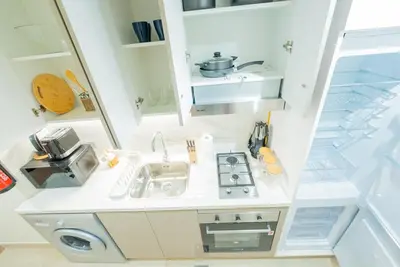 a small kitchen with a sink and a stove at Modern Studio Retreat in Dubai in Dubai