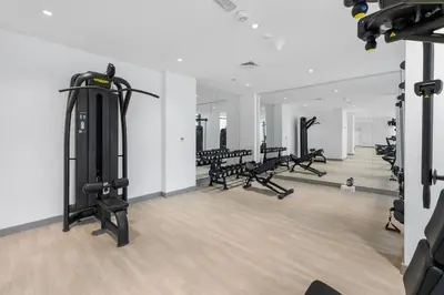 a gym with a row of treadmills and machines at Cozy Downtown Studio Dubai Retreat in Dubai