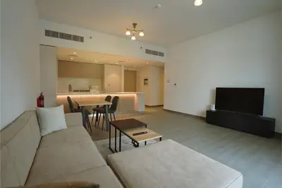 a living room with a couch and a table at Spacious 3BR in Sobha Hartland near Downtown in Dubai