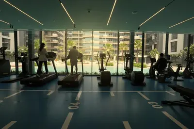 a group of people exercising in a gym at Spacious 3BR in Sobha Hartland near Downtown in Dubai