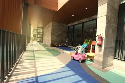 a small pink car parked in front of a building at Spacious 3BR in Sobha Hartland near Downtown in Dubai