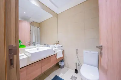 a bathroom with a sink and a toilet at Stunning Studio with Swimming Pool View in Dubai