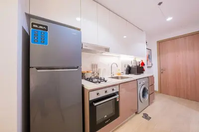 a kitchen with a stainless steel refrigerator and a dishwasher at Stunning Studio with Swimming Pool View in Dubai