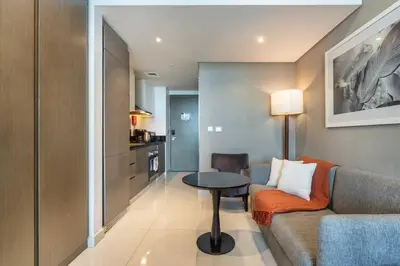 a living room with a couch and a table at Canal View & High Floor & Valet in Dubai