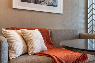 a couch with pillows and a table in a room at Canal View & High Floor & Valet in Dubai