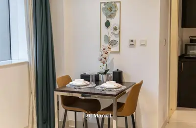 a dining room table with two chairs and a table at Luxury Studio close to Dubai Mall and Burj Khalifa in Dubai