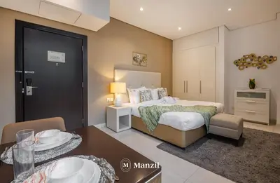 a bedroom with a bed and a dining room at Luxury Studio close to Dubai Mall and Burj Khalifa in Dubai