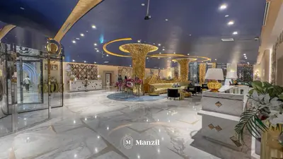 a lobby with gold columns and couches in a building at Waterfront Studio in Business Bay near Burj Khalifa in Dubai