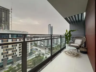 a balcony with a chair and a view of a city at Amazing Brand New 1BR in Dubai