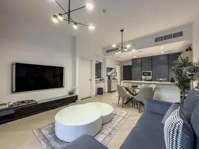 a living room with a couch and a table at Amazing Brand New 1BR in Dubai