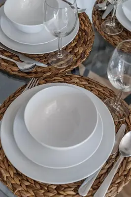 a table with white plates and wine glasses on it at GuestReady Holiday Homes - Industrial Chic in Dubai