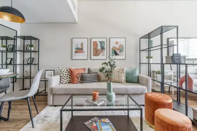 a living room with a couch and a table at GuestReady Holiday Homes - Industrial Chic in Dubai