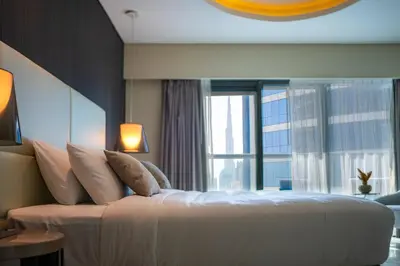 a bedroom with a large bed with a large window at High Floor Burj Khalifa View Luxurious 1BR in Dubai