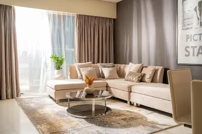 a living room with a couch and a table at High Floor Burj Khalifa View Luxurious 1BR in Dubai