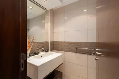 a bathroom with a white sink and a mirror at Blakely Tower, Park Island, Dubai Marina - Mint Stay in Dubai