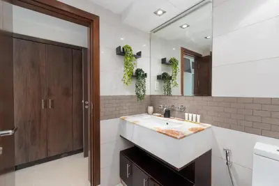a bathroom with a sink and a mirror at Blakely Tower, Park Island, Dubai Marina - Mint Stay in Dubai