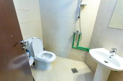 a bathroom with a toilet and a sink at Al Barsha Hostel for Girls in Dubai