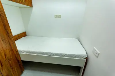 a small bedroom with a bed in a room at Al Barsha Hostel for Girls in Dubai