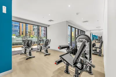 a gym with several treadmills and cardio machines at Studio in Azizi with Free Pool and Gym Access in Dubai