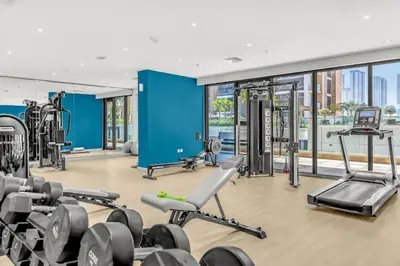 a gym with treadmills and weights in a building at Studio in Azizi with Free Pool and Gym Access in Dubai
