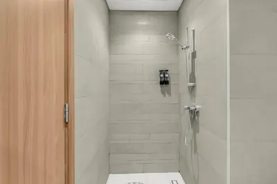 a bathroom with a shower with a glass door at Studio in Azizi with Free Pool and Gym Access in Dubai