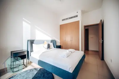a bedroom with a bed with two towels on it at Exclusive 2BR With City View Pool & Gym Access in Dubai