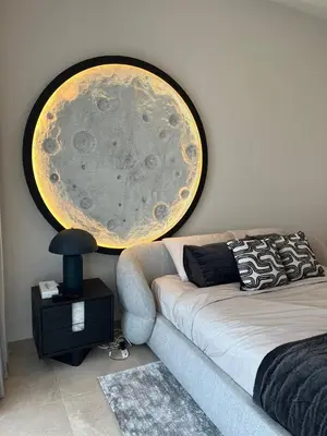 a room with a couch and a large painting on the wall at Burj Khalifa View Apartment in Dubai