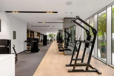 a gym with a row of exercise equipment in a building at Burj Khalifa View Apartment in Dubai