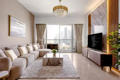 a living room with a couch and a table at Burj Khalifa View Apartment in Dubai