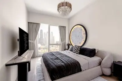 a bedroom with a bed and a large window at Burj Khalifa View Apartment in Dubai