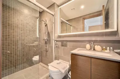 a bathroom with a shower and a toilet and a sink at FAM Living -Bright & Spacious Home in Sobha Hartland in Dubai