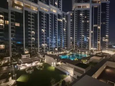 a view of a large city at night at FAM Living -Bright & Spacious Home in Sobha Hartland in Dubai