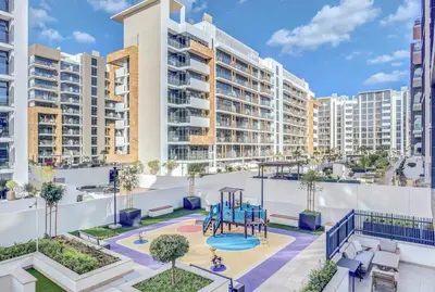 an apartment patio with a playground and buildings at Exclusive Downtown Dubai Studio in Dubai