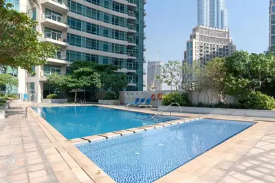a swimming pool in a city with tall buildings at The Lofts West, Downtown Dubai - Mint Stay in Dubai