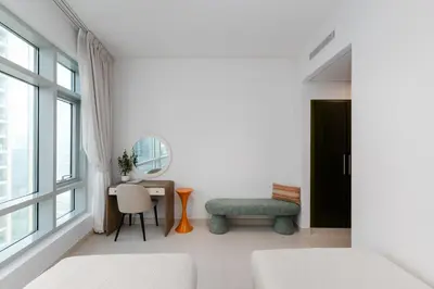 a bedroom with a desk and a chair and a window at The Lofts West, Downtown Dubai - Mint Stay in Dubai