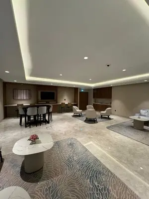a large lobby with tables and chairs in a building at Iconic Burj Khalifa, Fountain Views, Luxury 2BR in Sabkhah