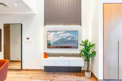 a bathroom with a sink and a painting on the wall at Luxury Apartment In JVC With Padel Gym Pool Cinema BBQ in Dubai